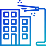 Building being power washed. The building is a light blue color with many windows. A power washer is spraying the building with water.