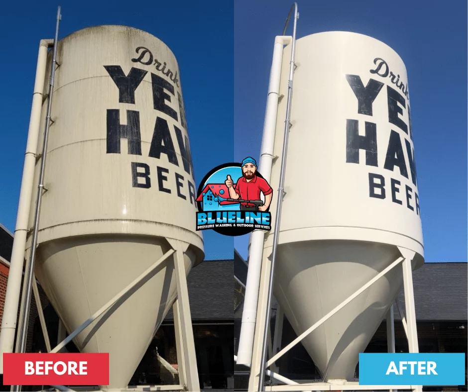Before and after pressure washing of a large silo tank with "Drink YE HA BEER" painted on it. The after image shows a dramatically cleaner, brighter surface.